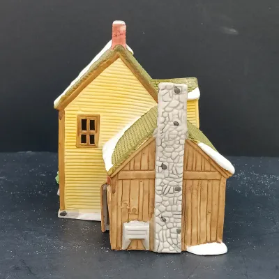 LOT 135: Department 56 New England Village Series Yankee Jud Bell Casting, Livery Stable & Boot Shop and Ben's Barber Shop