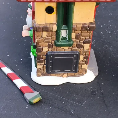 LOT 134: Department 56 North Pole Series Santa's Rooming House, Neenee's Dolls & Toys, and End of the Line