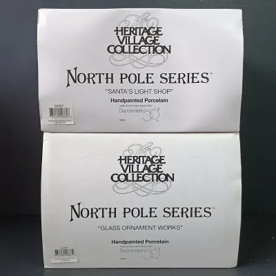 LOT 173: Department 56 North Pole Series Glass Ornament Works and Santa's Light Shop