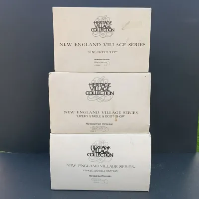 LOT 135: Department 56 New England Village Series Yankee Jud Bell Casting, Livery Stable & Boot Shop and Ben's Barber Shop