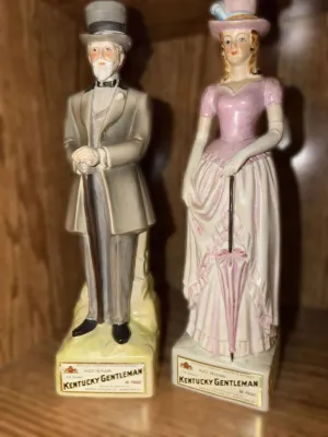 Pair of vintage Kentucky Gentleman bourbon whiskey decanters, featuring a gentleman in a top hat and a lady in a pink Victorian dress,...