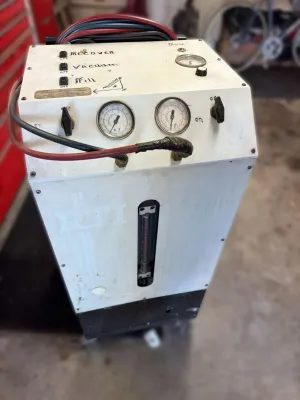 Vintage RTI refrigerant recovery, vacuum, and recharge station, showing moderate wear and hand-labeled controls.