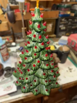 Vintage ceramic Christmas tree with green glaze, red plastic bulb inserts, and a yellow star topper.