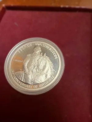 1982 George Washington 250th Anniversary of Birth commemorative silver half dollar coin in a protective plastic capsule.