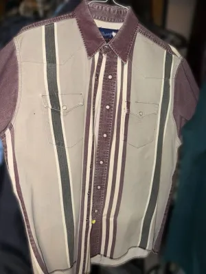 Vintage Wrangler short-sleeve western snap shirt featuring a vertical stripe pattern in purple, grey, and white, complete with dual chest...