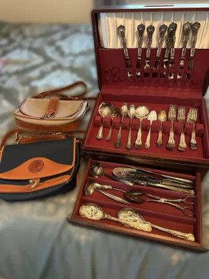 Vintage silver-plated flatware set in a wooden storage chest with red felt lining, shown alongside two vintage Dooney & Bourke All...