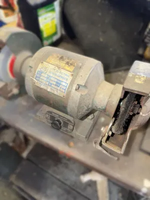 Vintage Jet Electric bench grinder, model BG-6, showing heavy wear and dust from workshop use.
