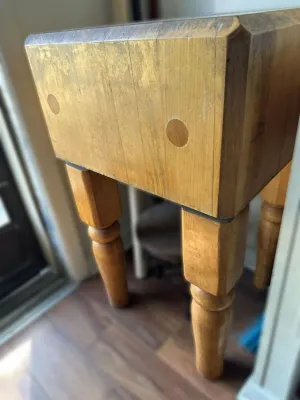 Vintage butcher block table featuring a thick end-grain maple top with dowel accents and turned wooden legs.
