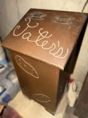 Vintage wooden potato bin featuring a hinged lid carved with "Taters" and simple potato illustrations on the front.