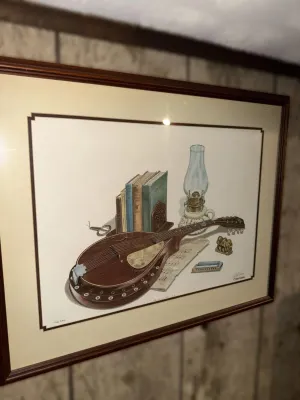Framed still life art print by C. Don Ensor, titled 'Plate XXII', depicting a mandolin, books, and a kerosene lamp, housed in a...