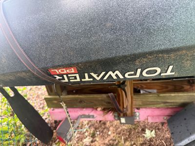 Old Town Topwater PDL kayak, showing some dirt and wear from outdoor storage on a trailer.