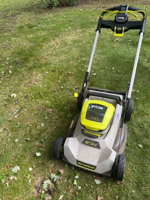 Ryobi 40V HP Brushless 21-inch self-propelled lawn mower, showing some light outdoor wear.