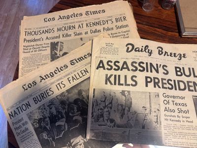 Sale Photo Thumbnail #64: Vintage newspapers from November 1963 covering the assassination of President John F. Kennedy, including copies of the Los Angeles Times and Daily Breeze.