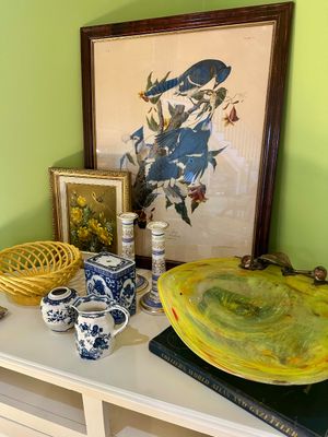 Assorted home decor items including a framed John James Audubon "Blue Jay" print, a yellow art glass bowl, blue and white...