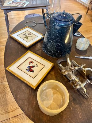 Assortment of vintage items including a blue speckled enamelware coffee pot, two framed butterfly prints, a stoneware crock, and a...