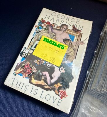 George Harrison "This Is Love" cassette single in original shrink wrap with a vintage Turtle's price sticker.