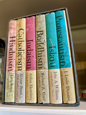Vintage six-volume boxed book set on world religions published by George Braziller, showing some wear and discoloration on the spines.