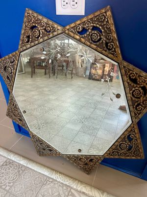 Vintage Star of David shaped wall mirror featuring an ornate, textured gold-tone frame with scrollwork details and a delicate etched...