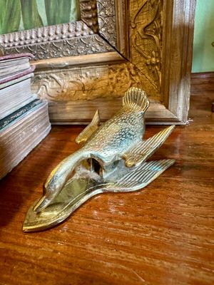 Vintage brass goose-shaped clip, likely a letter holder or paperweight, showing some natural patina and wear.