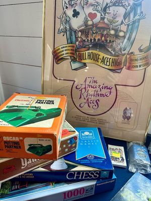 Vintage games and memorabilia, including an Oscar Jr. Electronic Putting Partner, a Golden Classic Games Chess set, and a framed poster...
