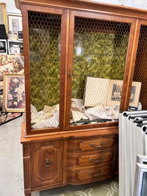 Sale Photo Thumbnail #23: Vintage French Provincial style wooden hutch featuring chicken wire cabinet doors, a green patterned interior backing, and a lower credenza with drawers and a cabinet.