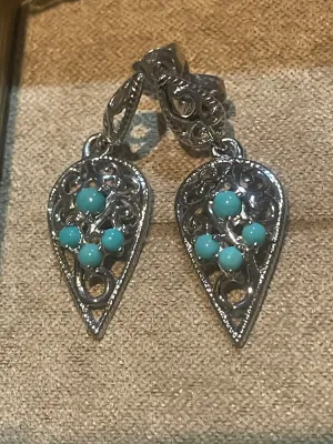 Sale Photo Thumbnail #78: Pair of sterling silver teardrop dangle earrings featuring intricate filigree work and small turquoise cabochons.