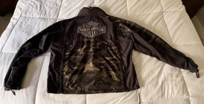 Harley-Davidson lightweight jacket featuring a camouflage pattern on the lower back and the classic bar and shield logo printed on the...