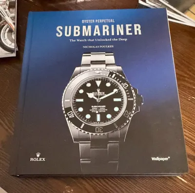 Hardcover book titled "Oyster Perpetual Submariner: The Watch that Unlocked the Deep" by Nicholas Foulkes, published by...