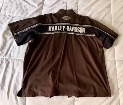 Harley-Davidson short-sleeve button-up shirt in brown and black, featuring embroidered branding across the back shoulders.