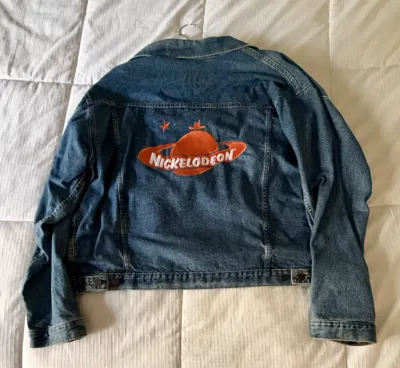 Vintage Nickelodeon denim jacket featuring the classic orange planet logo embroidered on the back, circa 1990s.