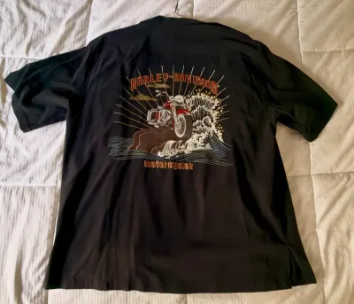 Black Harley-Davidson short-sleeve button-up shirt featuring a large embroidered graphic on the back of a motorcycle riding through ocean...