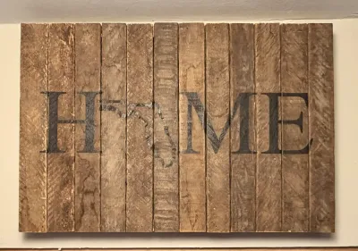 Rustic wooden pallet wall art spelling "HOME" with the state of Florida replacing the letter "O".