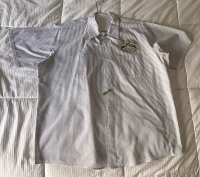 Vintage short-sleeve striped work shirt featuring dual chest pockets and an embroidered patch above the left pocket.