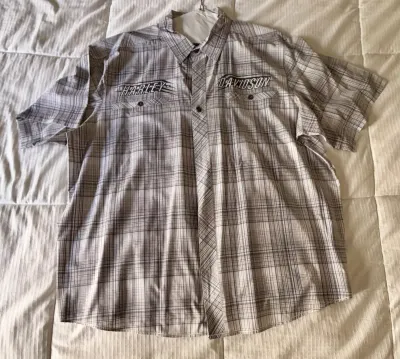 Harley-Davidson short-sleeve button-up shirt in a grey and white plaid pattern, featuring embroidered branding above the chest pockets.