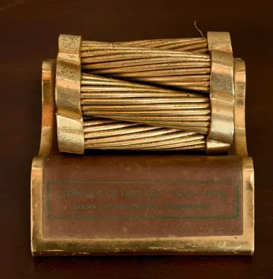 "Strands of History" Golden Gate Bridge suspender cable souvenir, featuring a section of original steel wire rope on a brass...