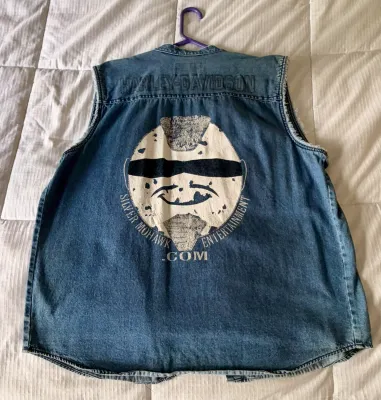 Vintage Harley-Davidson sleeveless denim shirt featuring a "Silver Mohawk Entertainment" graphic on the back.