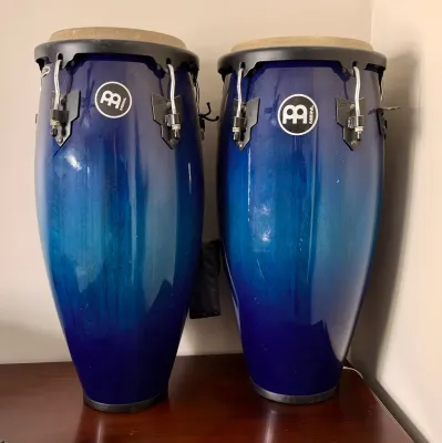 Pair of Meinl conga drums featuring a vibrant blue-to-teal gradient finish and black hardware.