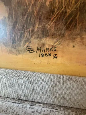 Close-up detail of an artist's signature reading "G.B. Marks 1968" on an oil painting with a linen-textured mat.