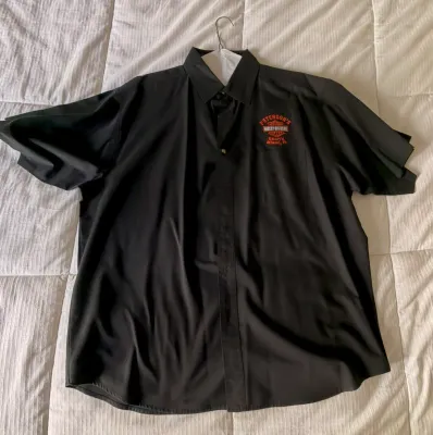Black short-sleeve button-down shirt featuring an embroidered Peterson's Harley-Davidson South Miami, FL logo on the left chest.