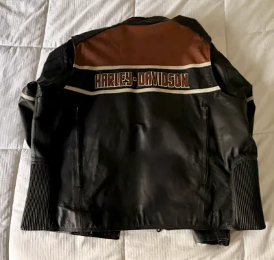Harley-Davidson leather motorcycle jacket featuring a black and brown colorblock design with embroidered branding across the back.