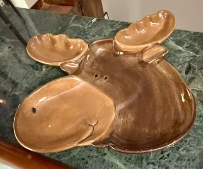 Whimsical ceramic moose-shaped serving platter with a glossy brown glaze, featuring divided sections for snacks or dips.