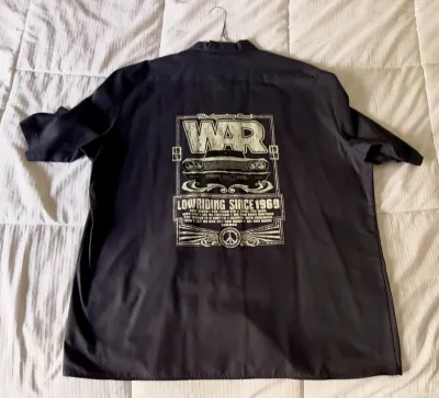 Black short-sleeve button-up shirt featuring a large graphic on the back for the band War, reading "Lowriding Since 1969" with...
