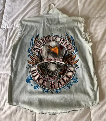 Sleeveless light-wash denim shirt featuring a large graphic on the back for the 2011 Murrells Inlet Bike Rally in South Carolina,...