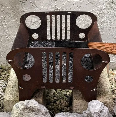 Custom metal fire pit designed to resemble a classic Jeep front grille, showing a rusted patina from outdoor use.