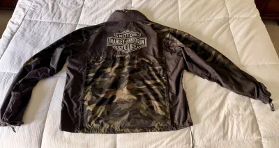 Harley-Davidson lightweight windbreaker jacket featuring a camouflage pattern and the classic bar and shield logo on the back.