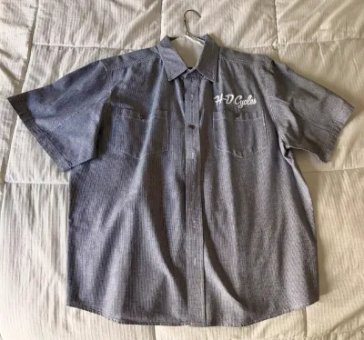 Harley-Davidson short-sleeve button-down shirt in a grey textured fabric, featuring 'H-D Cycles' embroidered in white script...