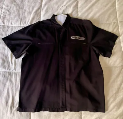 Black Harley-Davidson short-sleeve button-up work shirt featuring an embroidered logo patch above the left chest pocket.