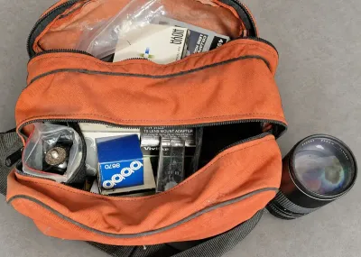 BAG FILLED WITH CAMERA LENS AND ACCESSORIES 