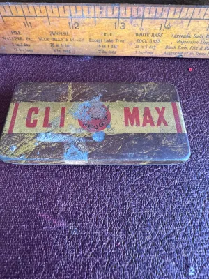 Sale Photo Thumbnail #198: An antique/vintage pocket-sized metal tobacco tin for Climax Plug tobacco, manufactured by the P. Lorillard Co. (Est. 1760) in the United States (Factory No. 10, Fifth District, N.J.). The lid features the red "CLIMAX PLUG" logo on a gold and brown stripe