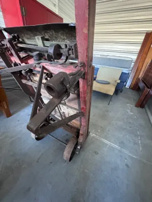 Sale Photo Thumbnail #22: An authentic antique Fairbanks wooden hand truck scale, combining a heavy-duty warehouse dolly with an integrated mechanical platform scale. Features a sturdy wood-plank bed, curved wooden handles, cast iron wheels, and the original mechanical weighing me
